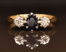 An 18ct gold ring set with an oval cut sapphire and diamonds, 2.9g, size M