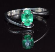 A 9k white gold ring set with an oval cut Zambian emerald, 2.6g, size P