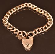 A 9ct gold curb link bracelet with heart padlock clasp, 16.2g