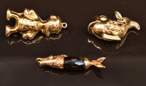 Three 9ct gold charms/ pendants comprising a fish, Donald Duck and a fish with a beaded body, 6.8g