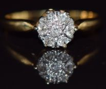 An 18ct gold ring set with diamonds in a cluster, 2.3g, size M