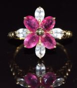 A 9k gold ring set with four oval cut rubies and white sapphires in a flower cluster, 3.7g, size Q