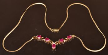A 9ct gold necklace set with oval cut rubies and diamonds, 4.7g