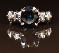 An 18ct white gold ring set with an oval cut sapphire, 4.8g, size M