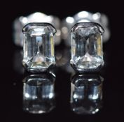 A pair of 18ct gold earrings set with an emerald cut aquamarine to each