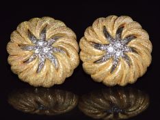 A pair of 18ct gold earrings set with diamonds in a textured star setting, 21g