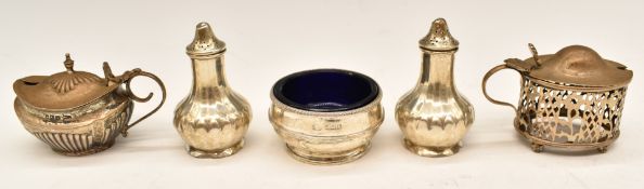 Hallmarked silver cruet items comprising open salt with blue glass liner, two mustards and a pair of