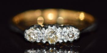 An 18ct gold ring set with three diamonds in a platinum setting, 2.3g, size L