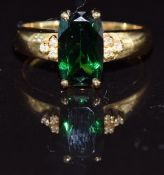 An 18ct gold ring set with tsavorite garnet and diamonds, 5.4g, size M