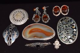 Two pairs of silver earrings set with pressed amber, silver brooch set with agate, Siam brooch, etc