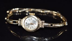 Renown 9ct gold ladies wristwatch with gold hands and hour markers, silver dial and Bravingtons 17
