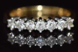 An 18ct gold ring set with seven diamonds, total diamond weight approximately 0.5ct, 3g, size k
