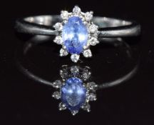 A platinum ring set with an oval tanzanite and diamonds, 4g, size M