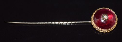 Victorian yellow metal stick pin set with a garnet cabochon and a rose cut diamond, 4.4g, 7cm long