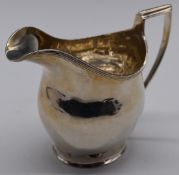 George V hallmarked silver milk jug in the Georgian style, Chester 1912, maker George Nathan &