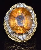 A 1970's 18ct gold ring, the mount made up of layers of pierced gold set with a large mixed oval cut