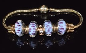 A 14ct yellow gold Pandora bracelet, the snake link chain suspending four Murano glass beads, a