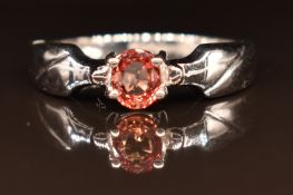 An 18ct white gold ring set with an orange sapphire, 3.4g, size M