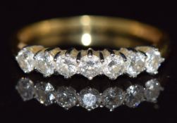 An 18ct gold ring set with seven diamonds, each approximately 0.1ct, 3.g, size S