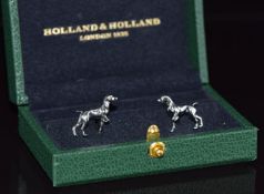 A pair of Holland & Holland stainless steel and gold plated cufflinks in the form of dogs, in fitted