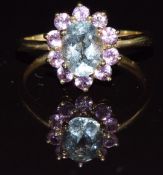 A 9k gold ring set with an oval cut aquamarine and pink sapphires, 2.4g, size Q