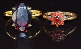 A 22ct gold ring set with a garnet and a 9ct gold ring set with garnets, 4.6g, size M