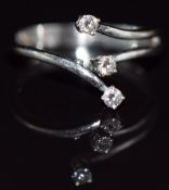 An 18ct white gold ring set with three diamonds, 3g, size M