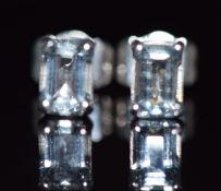 A pair of 9ct white gold earrings set with an emerald cut aquamarine to each