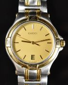 Gucci wristwatch ref. 9040M with date aperture, gold hands and dial, gold plated bezel, stainless