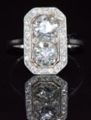 Art Deco platinum ring set with old round cut diamonds of approximately 1.02ct and 0.94ct, within