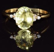 An 18k gold ring set with an oval cut chrysoberyl and diamonds, 3.2g, size Q