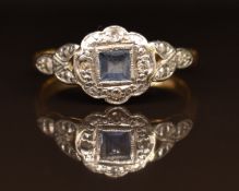 An 18ct gold ring set with a sapphire and diamonds in a platinum setting, 3g, size L