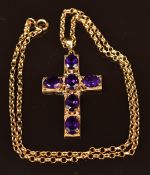 A 9ct gold cross pendant set with oval cut amethysts, on 9ct gold chain, 11.4g