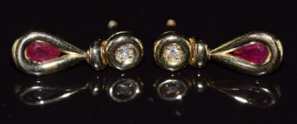 A pair of 9ct gold earrings set with a round cut ruby and diamond to each, 1.8g