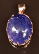 An 18ct gold pendant set with a tanzanite cabochon, 3.6g