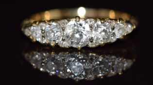 An 18ct gold ring set with five graduated diamonds and ten smaller diamonds, the largest
