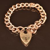 A 9ct rose gold curb link bracelet with heart padlock clasp, 18.7g