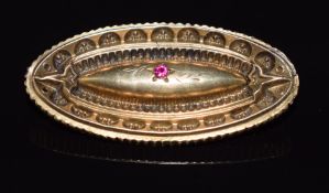 Victorian mourning brooch set with a ruby, verso a locket compartment, 3.7cm long