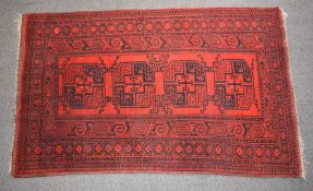Afghan rug, with red ground and four central guls, 205 x 122cm