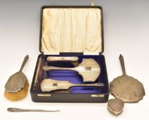 Cased hallmarked silver dressing table set, further hallmarked silver hand mirror and brush,