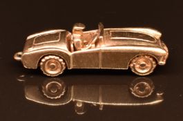 A 9ct gold charm in the form of an MG MGA sportscar, 6.3g