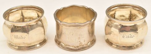 Three hallmarked silver napkin rings, including a pair, weight 85g