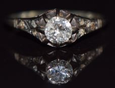 A c1930 platinum ring set with a diamond of approximately 0.3ct with diamond encrusted shoulders,