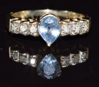 A 9k gold ring set with a pear cut sapphire measuring approximately 1.1ct and diamonds, 3.3g, size