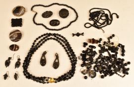 A collection of Victorian jet jewellery including beads, brooches, vulcanite earrings, banded agate,