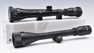 Two Bushmaster 4x40 rifle scopes one with scope mounts, in Hawke Airmax box.