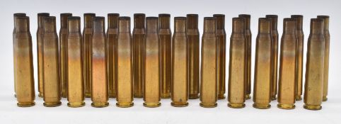 Twenty-five .50 calibre brass rifle cartridge cases.