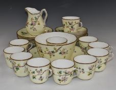 Approximately thirty seven pieces of late 19th/20thC porcelain tea ware decorated with blossom
