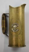 WW1 trench art jug fashioned from a German shell case, dated 1915, with Somerset Regiment badge,