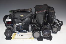 Three Minolta 35mm SLR cameras comprising Dynax 7000i with 35-70mm 1:4 lens, 7000 with 70-120mm